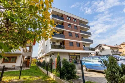 a building with a car parked in front of it at Platinum_Luxury_Apartment in Teslić