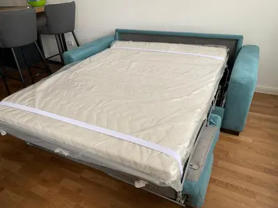 a bed in a room with a blue frame at Zeus apartman in Banja Luka