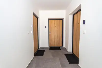 a hallway with two doors and a tile floor at Apartman Krželj A1 in Livno