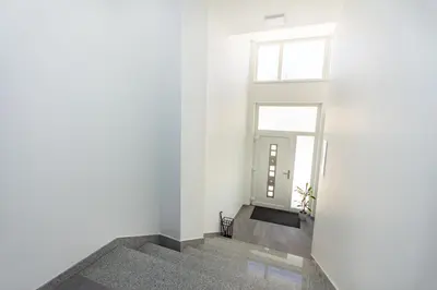 a hallway with white walls and a window at Apartman Krželj A3 in Livno