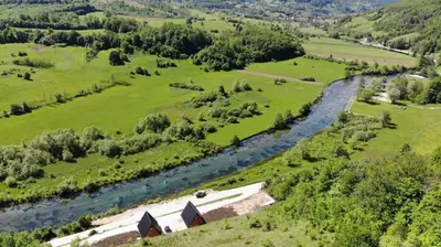 an aerial view of a river in a field at Bungalov Mila in Šipovo