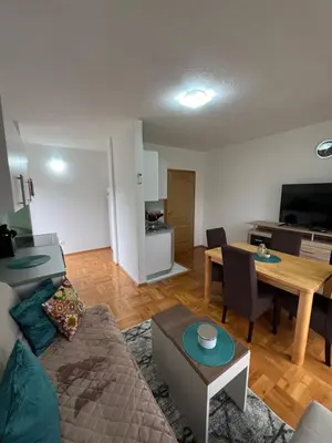 a living room with a couch and a table at Teal Apartment 2 in Bihać