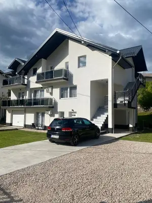 a black car parked in front of a house at Apartman Rawda 2 in Jajce