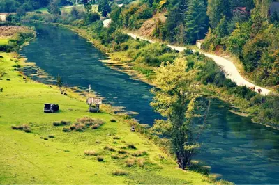 an aerial view of a river in a field at Bungalovi izvor Plive 3 in Šipovo