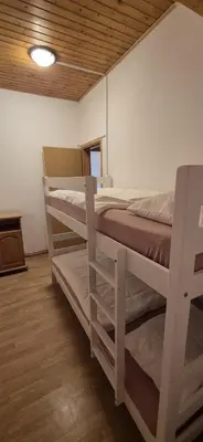 a bedroom with two bunk beds in a room at Apartmani Viktory in Šišava