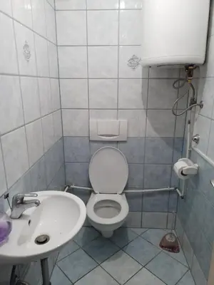 a bathroom with a toilet and a sink at apartman SM IK 2 in Šujica