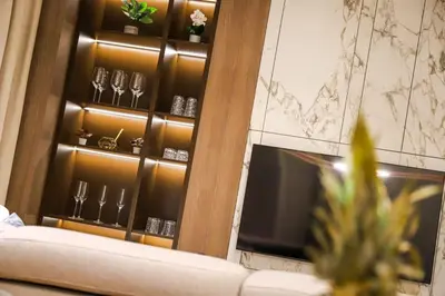 a room with a wine cabinet with wine glasses at ModernApartmentsBL in Banja Luka