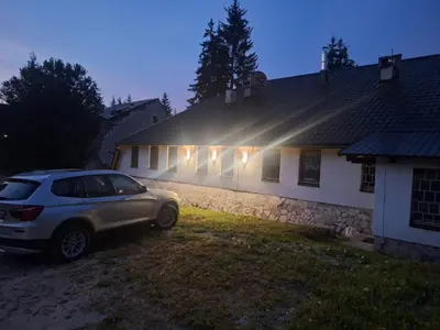 a car parked in front of a house at night at Viktory in Vlasic