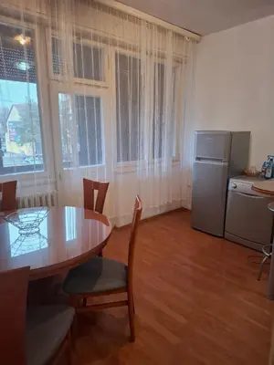 a kitchen with a table and a refrigerator at Mia lux centar in Banja Luka
