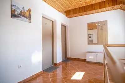 a room with white walls and a tile floor at Apartmani Biser Kupresa 1 in Kupres
