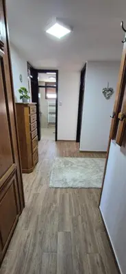 an empty room with a hallway with wooden floors at Center Heritage Apartment in Teslić
