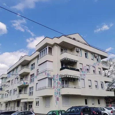 a tall white building with colorful decorations on it at Stan na dan Banja Luka in Banja Luka