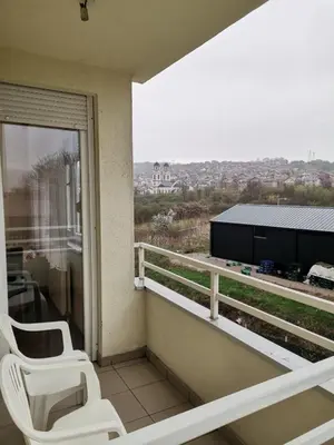 two white chairs sitting on a balcony with a view at Apartman Anja in Banja Luka