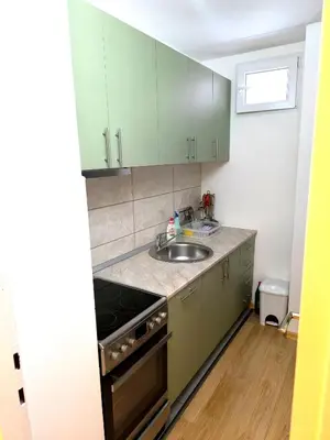 a kitchen with green cabinets and a sink at Apartment Sneki Banja Luka in Banja Luka