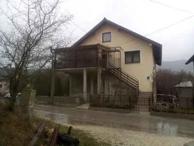 a house with a balcony on the side of it at studio SM IK 3 in Tomislavgrad