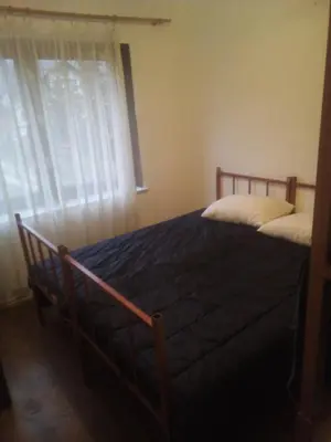 a bedroom with a bed and a window with curtains at stidio sa 1 spavaćom sobom SM IK 4 in Tomislavgrad