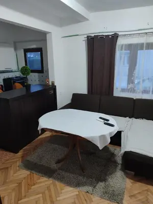 a living room with a coffee table in front of a couch at Apartman Luna in Vrbanja