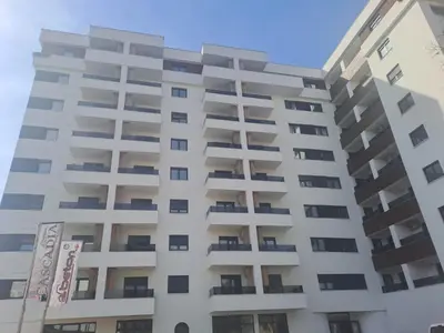 an apartment building with balconies on a sunny day at Apartman NINA in Doboj