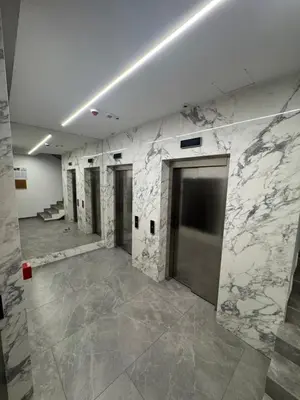 a large room with marble walls and doors in a building at Apartman AK IX in Banja Luka