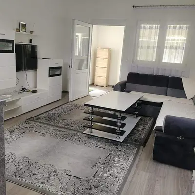 a living room with a couch and a table at Apartman Oaza mira-Visoko in Visoko