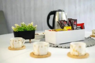 a table with cups and a tea set on it at Apartman D&A in Brekovica