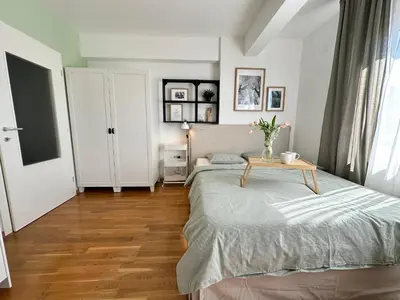 a bedroom with a bed and a table at Studio Mint&White Borik in Banja Luka