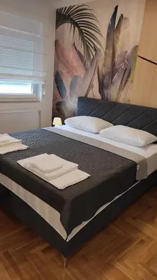 a large bed with towels on top of it at Apartment Lena 51 in Banja Luka