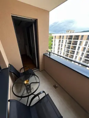 a balcony with a table and chairs on a building at Elita SPA in Doboj