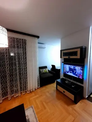 a living room with a flat screen tv and a couch at AnyBL01 in Banja Luka