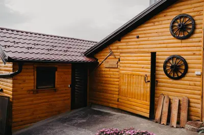 a wooden cabin with a wooden door and windows at Djedovo ognjište 2