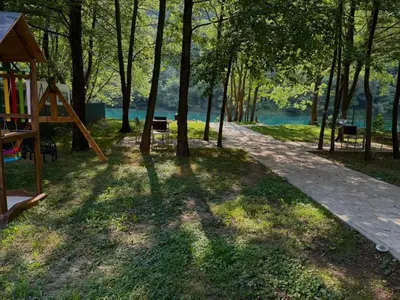 a playground in a park next to the water at UNA Dream in Ivišovo Greblje