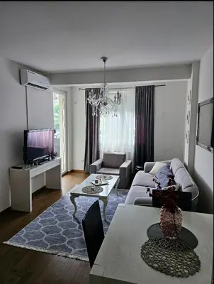 a living room with a couch and a table at Comfort u blizini Klinickog Centra Banja Luka in Lauš