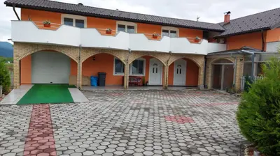 an orange and white house with a courtyard at 4 Room - 2 story Apartment Kuckovic in Bihać