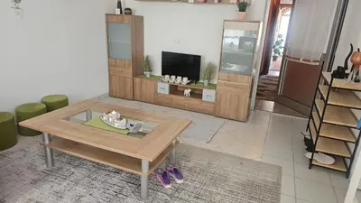 a living room with a coffee table and a tv at 4 Room - 2 story Apartment Kuckovic in Bihać