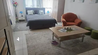 a bedroom with a bed and a table and a chair at 4 Room - 2 story Apartment Kuckovic in Bihać