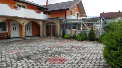 a house with a stone patio in front of it at 1 Room Suite Kuckovic in Bihać