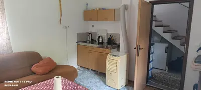a living room with a couch and a sink and a kitchen at Holiday home una in Bosanska Krupa