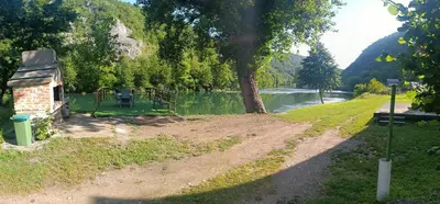a path next to a river with a tree at Holiday home SaFari in Bosanska Krupa