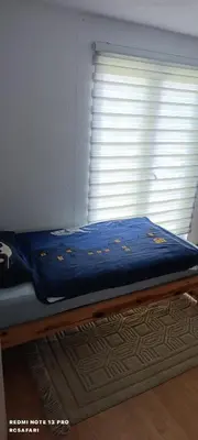 a bed in a room with a window at Holiday home SaFari in Bosanska Krupa