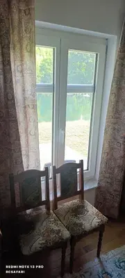 a table and two chairs in front of a window at Holiday home SaFari in Bosanska Krupa
