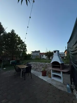 a patio with a grill and a table and chairs at Royal Luxury Apartment in Bihać