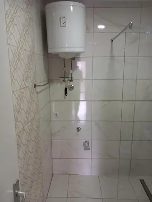 a bathroom with a shower with a glass door at Apartman AM Tuzla in Tuzla