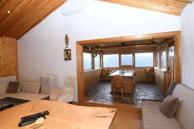 a living room with a couch and a table at Ivanović Vikendica