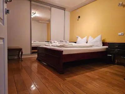 a bedroom with two beds and a large mirror at Ramonda Banja Luka in Banja Luka