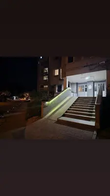 a group of stairs in front of a building at night at Ramonda Apartment Banja Luka in Banja Luka
