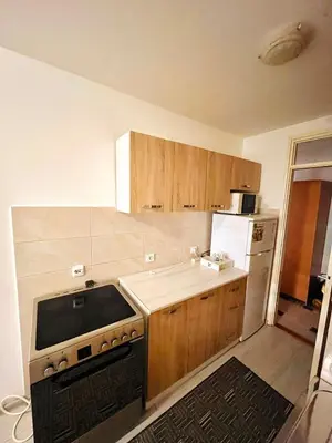 a kitchen with a stove and a refrigerator at Apartman Buric