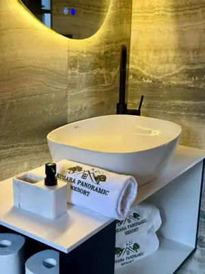 a bathroom with a sink and towels on a shelf at Test Property in Bosanska Gradiška