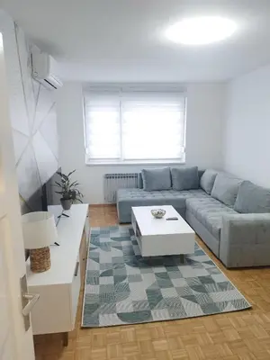 a living room with a couch and a coffee table at Apartman Harmony N&D in Starčevica