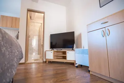 a living room with a television and a dresser at Apartman in Kupres