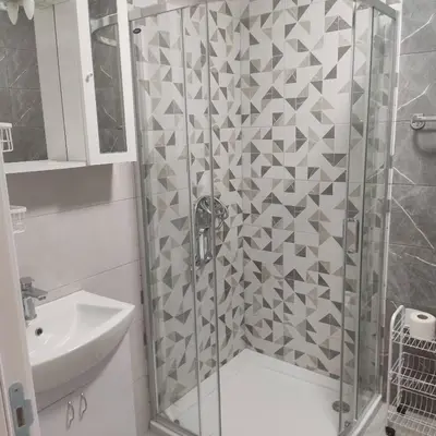 a shower with a glass door next to a sink at Ela in Banja Luka